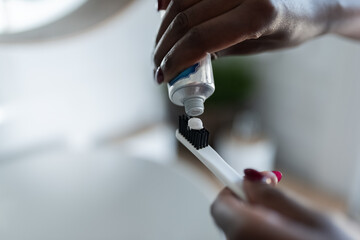 Squeezing toothpaste on brush