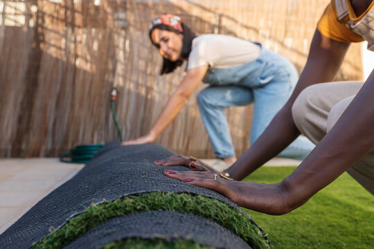 Women installing artificial grass