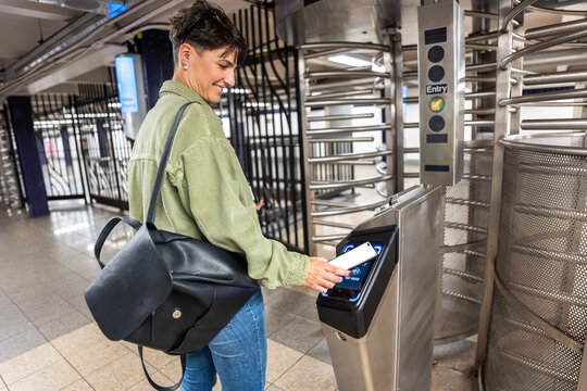 Woman using smartphone to access New York City Subway in Manhattan
