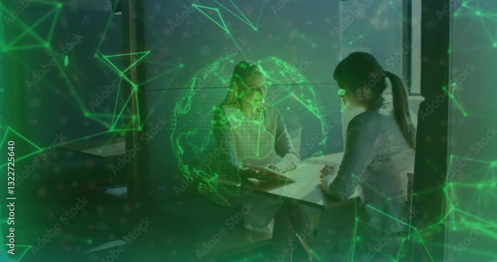 Poster two women discussing at table with digital globe and network animation overlay