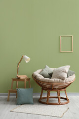 Interior of living room with lamp and pillows on armchair