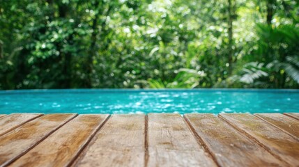 A serene wooden deck overlooks a tranquil pool surrounded by lush greenery, creating a peaceful oasis in nature.