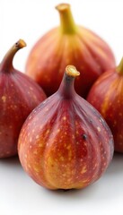 Obraz premium Close-up of plump, sun-dried figs against white backdrop , healthy snack, delicious figs, ingredient
