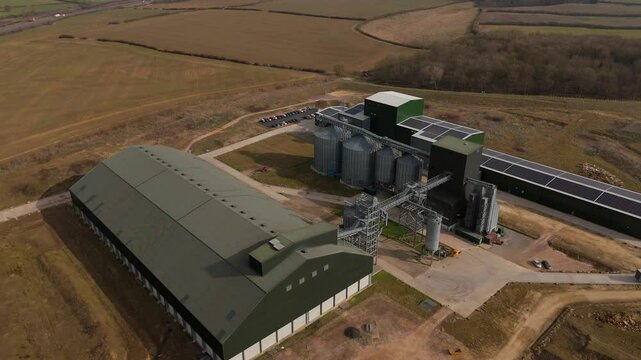 Aerial view of agricultural corn grain processing facility in England UK Europe on a sunny day. Food security grain silos storage and distribution.