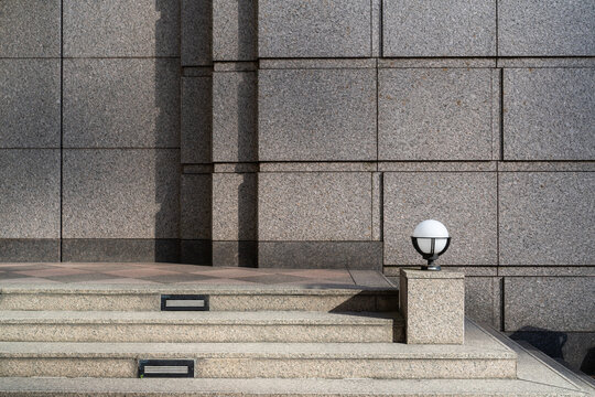 Modern Stone Wall with Stairway and Lamp
