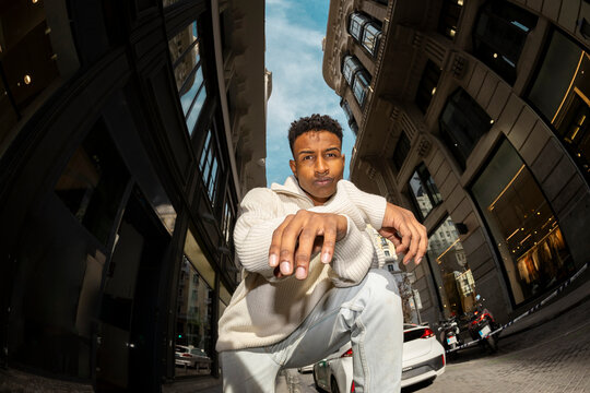 Fisheye. Urban portrait of man in Madrid city street posing