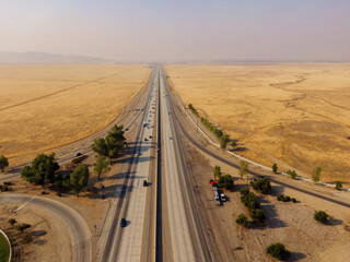 Aerial view of Interstate 5 highway running through Grapevine, California farmland. Cars and trucks...