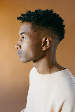 Studio profile portrait of young handsome man with serious expression