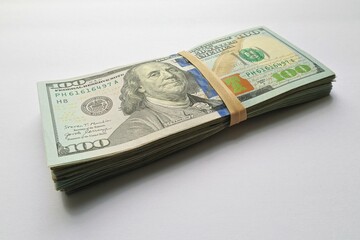 Ten thousand by hundreds 100 bills tied by rubber band