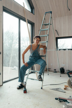 Builder completing repairs in a modern construction space