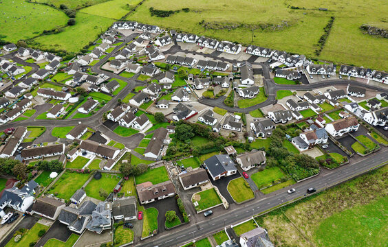 Aerial view of recent private housing development on west edge of coastal village of Portballintrae near Bushmills, Northern Ireland