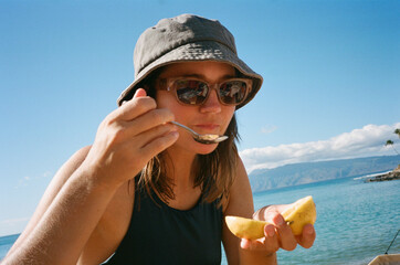 35mm film eating fruit at beach 