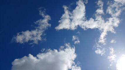 A clear blue sky background with scattered clouds 