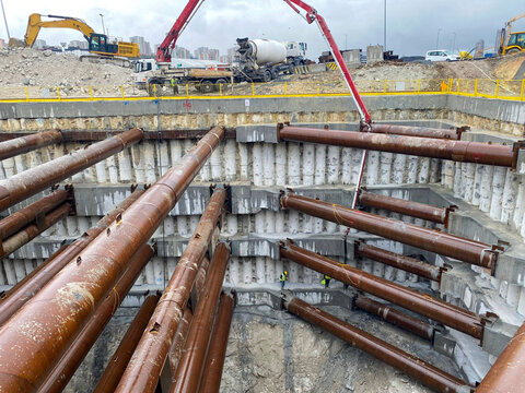 Deep foundation construction with steel beams, concrete reinforcements