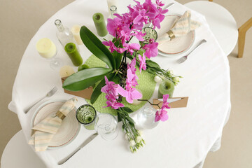 Beautiful table setting with orchid flower for wedding celebration in room, top view
