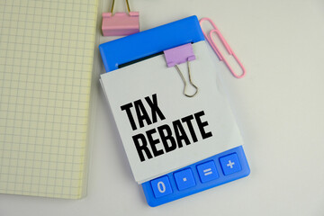 Close-up Of Person Hand Using Calculator With Tax Word On Wooden Blocks.