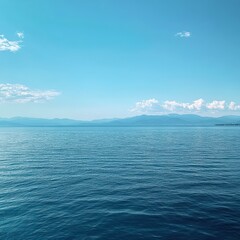 Fototapeta premium A small, vibrant sailboat glides gracefully across the deep blue ocean, its white sails billowing in the gentle breeze under a clear, sunny sky dotted with fluffy clouds.