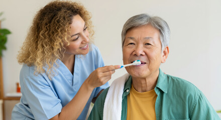 Female nurse assisting elderly asian male with teeth brushing in care setting