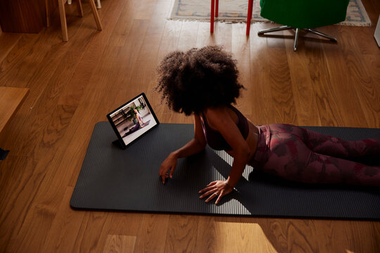 Woman exercising with tutorial