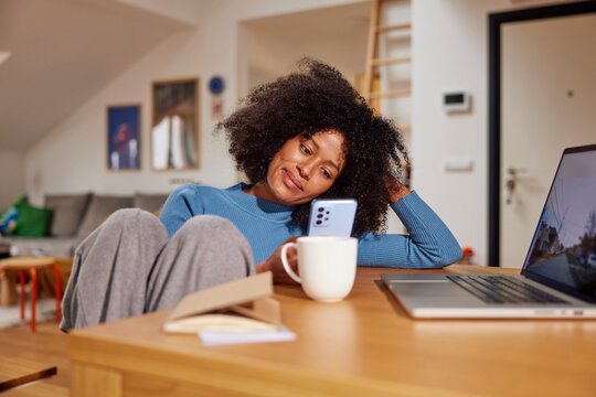 Woman uses phone at home