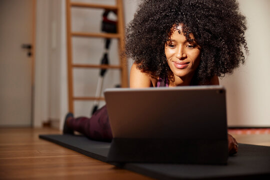 Woman exercising with tutorial