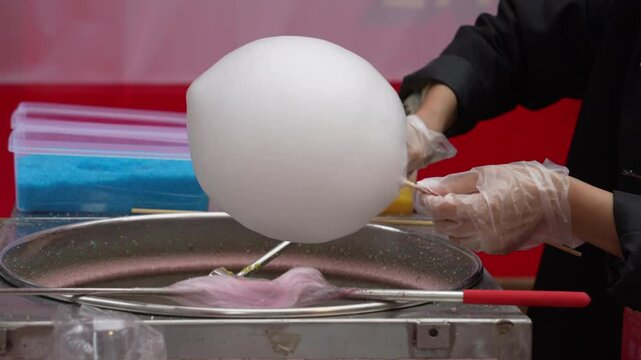 Hand rolled cotton candy into candy thread machine.