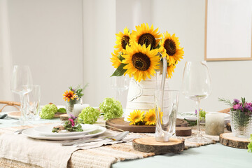 Served dining table with beautiful sunflowers, floral decor and candles