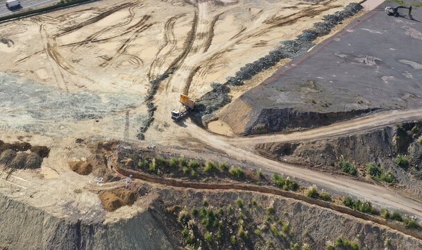 trucks dumping excavation on vacant land