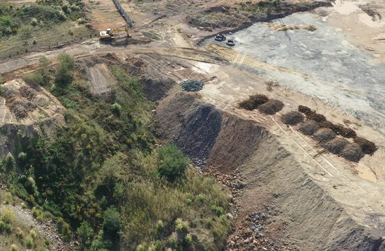 trucks dumping excavation on vacant land