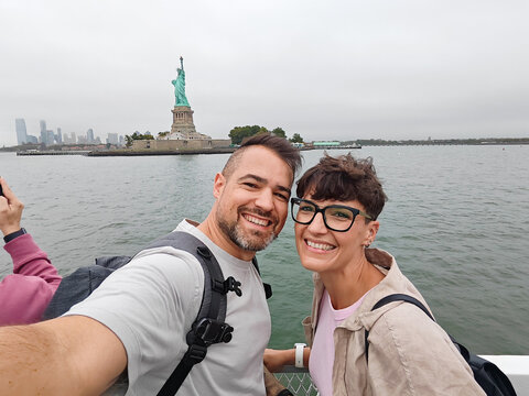 Tourists taking selfie with Statue of Liberty in New York City