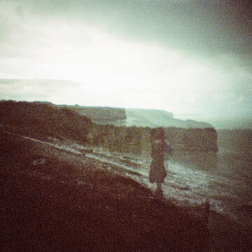 Double Exposure Coastal Landscape with Cliffs and Figure