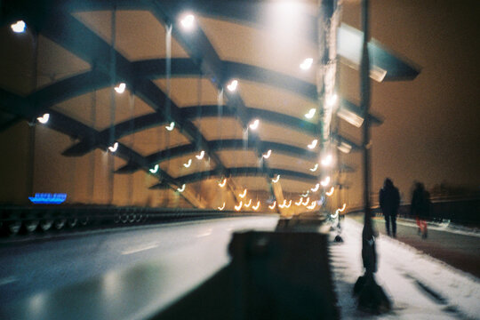 Blurred Night Scene with Modern Bridge Illuminated Arches