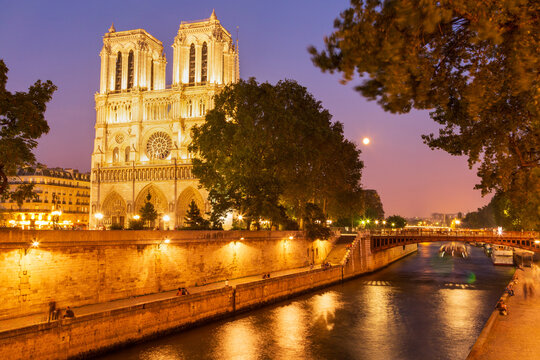 Moon rising over Notre Dame. The Seine. Paris.