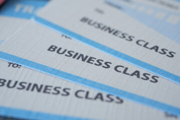 Business class travel tickets displayed with travel documents