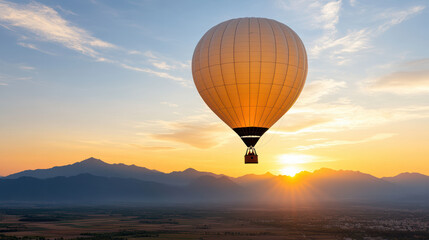 Obraz premium hot air balloon soaring against stunning sunset over mountains