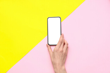 Female hand with mobile phone on color background
