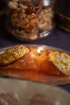 Golden Cannolo Candle with Nutty Backdrop