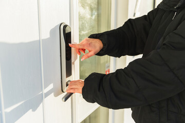 Unrecognizable woman Using Smart Lock to Open Door
