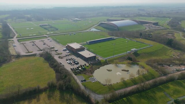 Aerial view over football soccer training grounds in the UK Europe on a sunny hazy early morning . premier league sports training