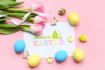 Greeting card with Easter eggs, wooden rabbits and beautiful tulip flowers on pink background
