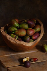 fresh matoa fruits on wooden table