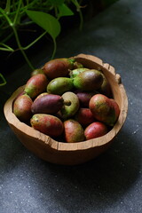 Matoa fruits in a wooden bowl 