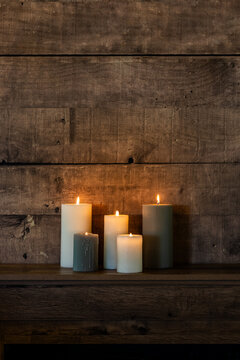 Warm candlelight against rustic wooden backdrop