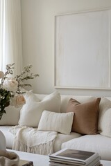 Minimalist living room with beige sofa, pillows, and art.