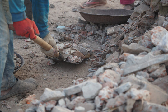 Construction workers clearing debris from a building site