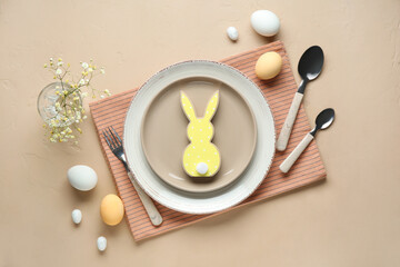 Stylish table setting for Easter celebration with gypsophila flowers on beige background