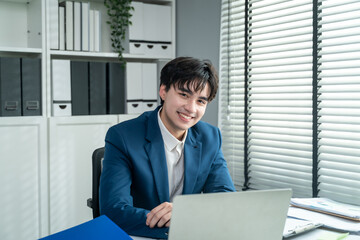Fototapeta premium Portrait of Asian young businessman working in the office workplace. 