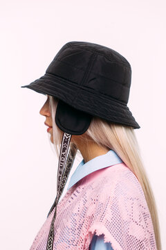Stylish model showcases black bucket hat and pink lace