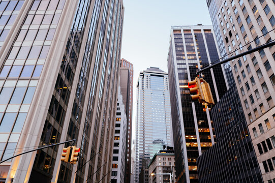 Urban street with tall buildings and traffic lights