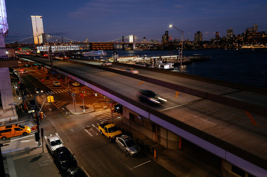 Elevated urban highway overlooking waterfront at night
